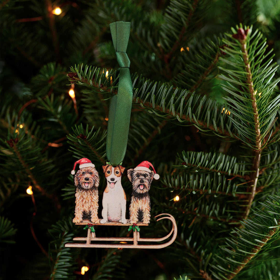 wooden dog christmas tree decoration with green ribbon